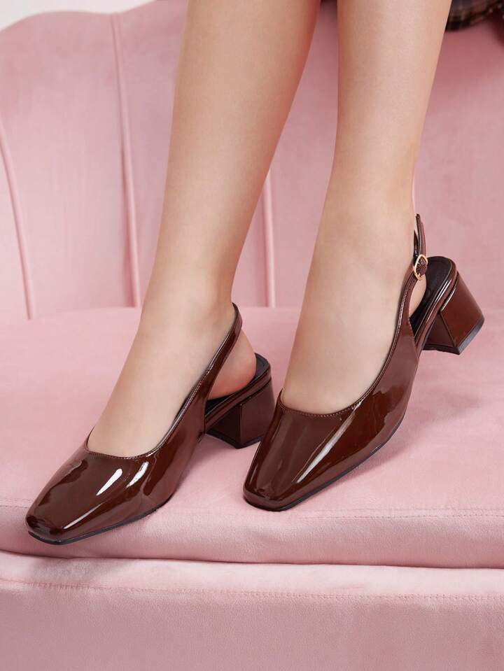 Slingback block heel pumps in cherry red patent finish with square toe and adjustable ankle buckle strap