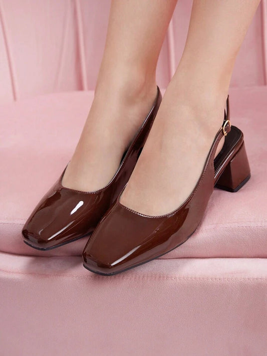 Slingback block heel pumps in cherry red patent finish with square toe and adjustable ankle buckle strap
