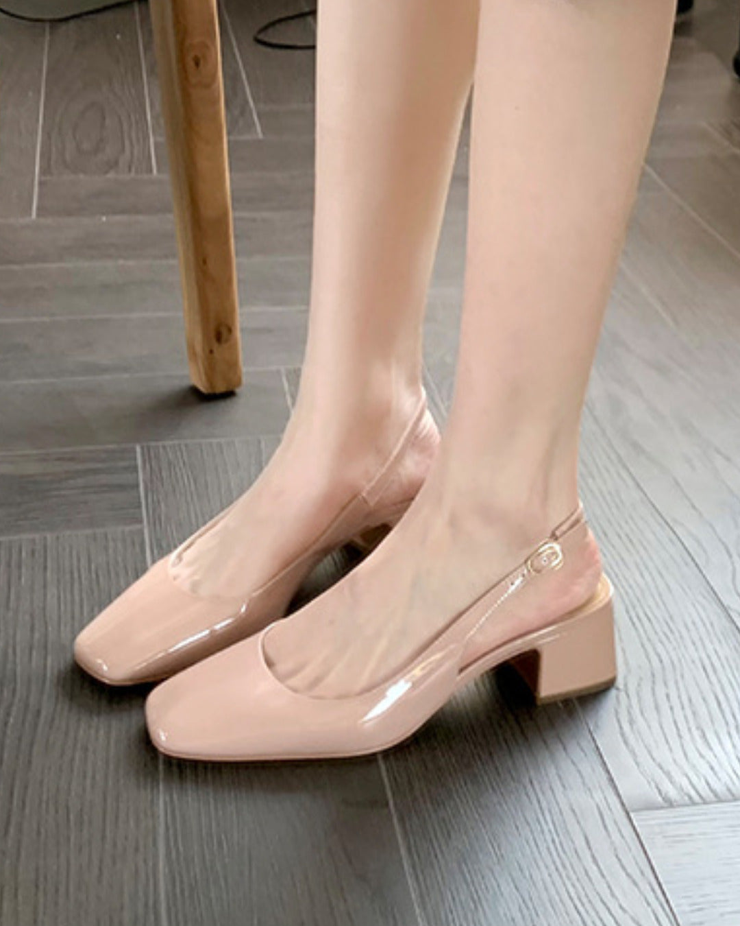Slingback block heel pumps in nude patent finish with square toe and adjustable ankle buckle strap