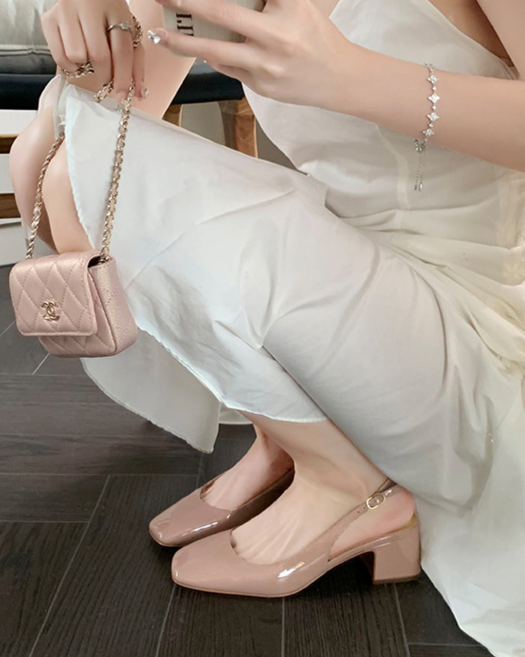 Slingback block heel pumps in nude patent finish with square toe and adjustable ankle buckle strap