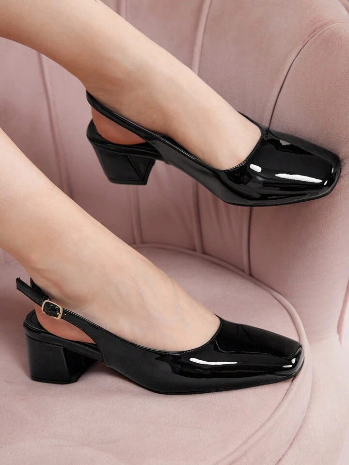 Slingback block heel pumps in black patent finish with square toe and adjustable ankle buckle strap