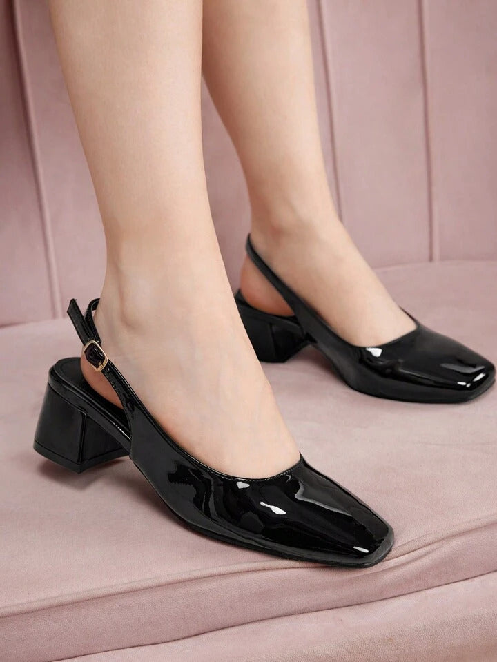 Slingback block heel pumps in black patent finish with square toe and adjustable ankle buckle strap