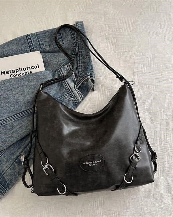 Black slouchy hobo shoulder bag in sumptuous distressed leather with silver hardware and adjustable crossbody straps