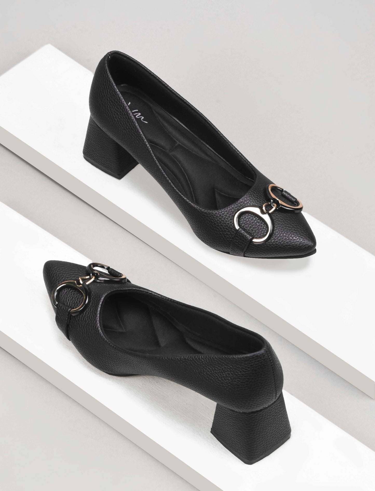 women's block heel pumps featuring a pointed toe and a decorative buckle embellishment
 Black