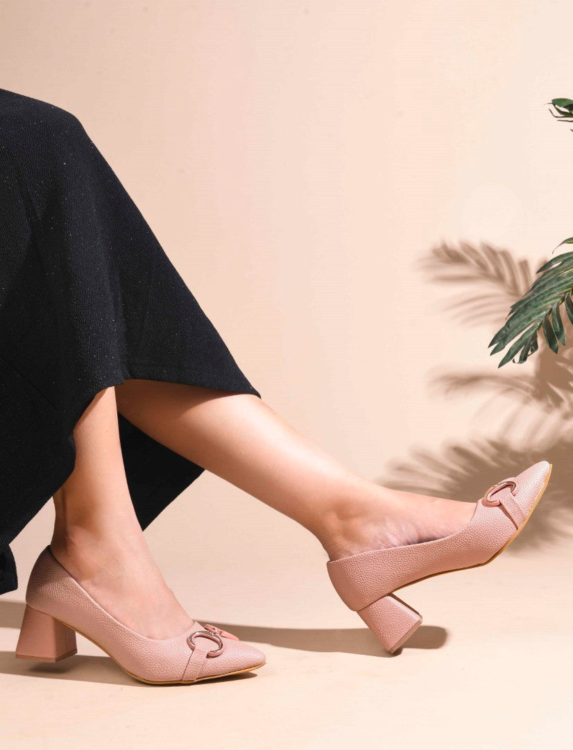 women's block heel pumps featuring a pointed toe and a decorative buckle embellishment
 Peach