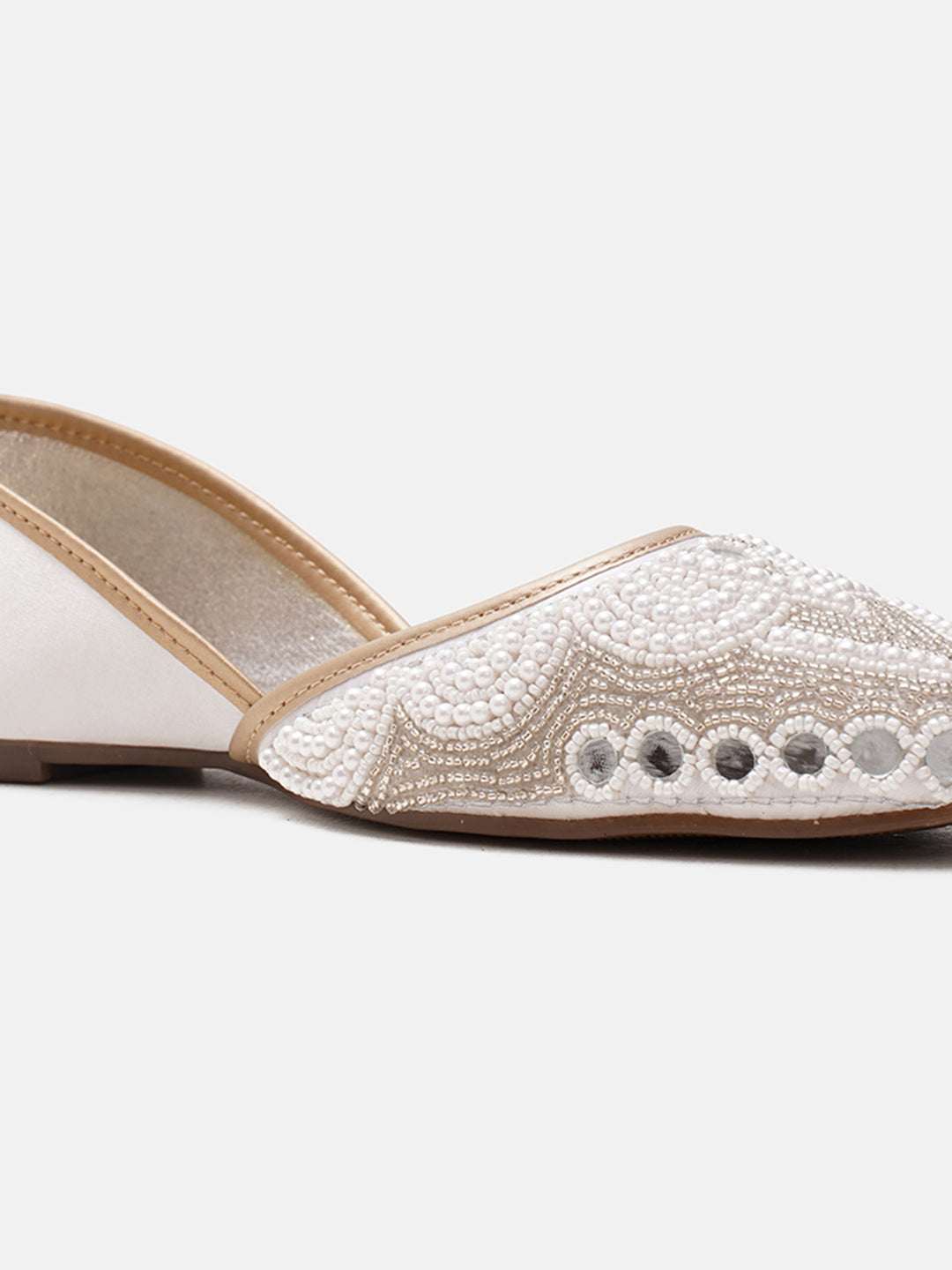 traditional juttis heavily embellished with pearls and beads on the upper
 Green