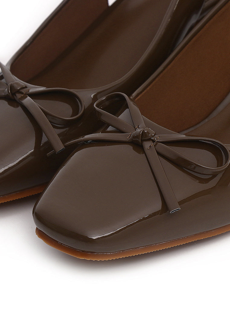 Women's brown patent Mary Jane slingback block heels with bow detail, square toe and chunky heel.