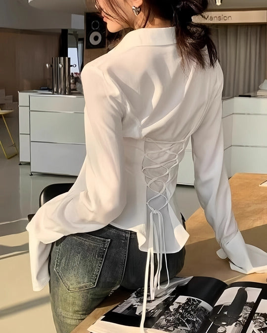 White women's long sleeve blouse featuring back lace-up corset tie, flared bell cuffs, buttoned front, slim fit