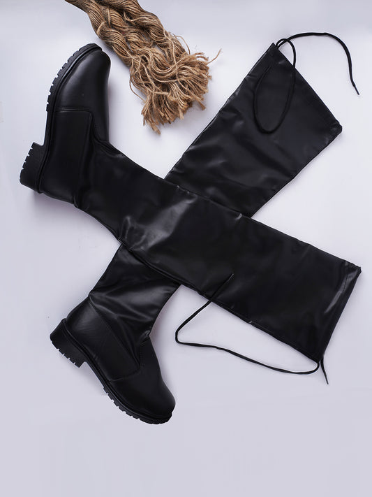 Over-the-knee black boots for women featuring flat sole, round toe, and smooth stretch faux leather finish