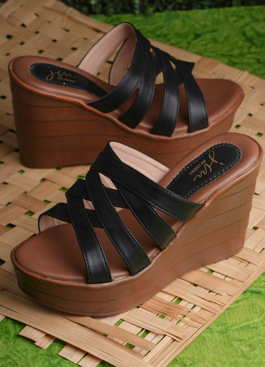 Black strappy crisscross platform wedge heels for women with brown sole and slip-on open-toe design.